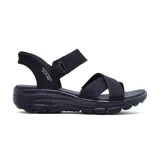 Sandalias Skechers Hands Free Slip-ins Relaxed Fit: Easy Going - Somewhere Sunny de color negro. Diseñadas con Heel Pillow, capellada de cuero sintético con paneles elásticos dobles y tiras cruzadas en el empeine, y plantilla con amortiguación Yoga Foam.