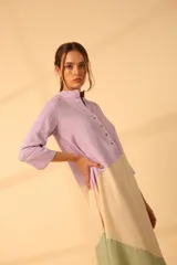 Túnica midi color beige con corte geométrico en lila y verde. Tiene cuello mao con botones y mangas 3/4.