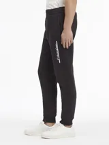 Pantalón de jogging negro con cintura elástica, bolsillos laterales y logo de Calvin Klein estampado en blanco en la pierna derecha.