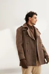 Saco marrón de lana con solapa, doble abotonadura, bolsillos, canesú y charreteras.