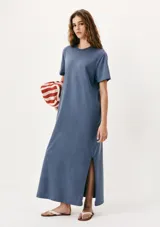 Vestido largo azul con corte recto, cuello redondo y mangas cortas. Presenta aberturas laterales en el ruedo.
