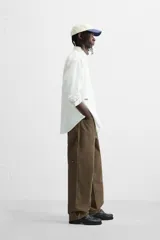 Pantalón color verde oliva de corte recto, confeccionado en algodón. Cuenta con bolsillos frontales, traseros y laterales tipo cargo, además de una tira multifunción.