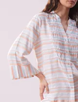 Blusa estampada a rayas horizontales en tonos celeste, blanco y naranja, con cuello mao, escote en V y abertura con botones. Delantero con punto smock. Manga ¾ con terminación amplia.