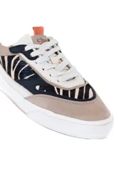 Championes urbanos de cuero vacuno color beige con estampado animal print en negro y blanco, detalles en azul marino y naranja. Plataforma blanca con suela de goma.