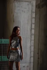 Top corto de color plateado con diseño de rayas, ajuste ceñido y tirantes delgados.