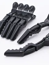 Pack de seis pinzas negras para el pelo, con agarre antideslizante y resorte metálico.