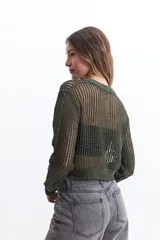 Sweater negro de tejido calado con escote redondo y mangas largas.