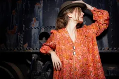 Camisa de seda color naranja con estampado floral, corte amplio, mangas abullonadas y frunce en hombros y espalda.