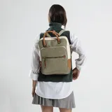 Mochila combinada en tres tonos de símil cuero: marrón, beige y negro. Tiene doble bolsillo frontal, asa de mano y correas regulables. En su interior tiene dos bolsillos con cierre y uno abierto con división para celular.