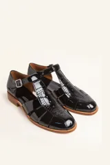 Sandalia marrón de cuero vacuno con diseño de tiras entrecruzadas, hebilla lateral y taco bajo de 2,5 cm.