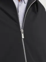 Campera tipo sobrecamisa negra con cierre de cremallera, cuello clásico, mangas largas con puños abotonados y bolsillos frontales. Confeccionada en tejido plano de poliéster reciclado.