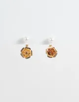 Aros pasantes dorados con perlas y flores de metal.
