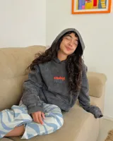Canguro gris con efecto lavado, de corte holgado y con capucha. Presenta un estampado pequeño en el pecho y un bolsillo tipo canguro.