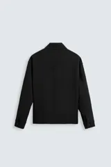 Sobrecamisa negra de corte cuadrado, con cuello solapa, manga larga con puños abotonados, bolsillos tipo parche en el pecho, bolsillos laterales y cierre frontal con botones.