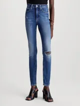 Jeans skinny de tiro alto color azul medio, con lavado gastado y roturas en las rodillas.