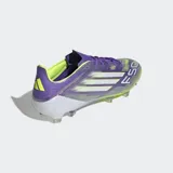 Championes de fútbol Adidas F50 Elite para terreno firme, con exterior en tonos morado iridiscente y verde lima, tres franjas plateadas y cordones morados. Poseen suela con tapones transparentes.