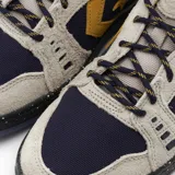 Championes Converse As-1 Pro Ox color beige con detalles en azul marino y amarillo. Confeccionados en gamuza y tela Cordura.
