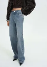 Pantalón de jean celeste de corte recto, con strass plateados en toda la prenda.