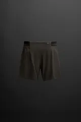 Shorts deportivos color marrón confeccionados en tejido técnico ligero y elástico. Cuenta con cintura elástica ajustable con cordón interior, bolsillos frontales, bolsillo trasero con cierre de cremallera, forro interior y bajo con aberturas laterales.