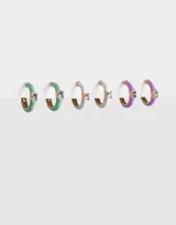 Set de tres pares de aros tipo argolla con apliques de strass. Un par es de color verde agua, otro gris y el tercero lila.