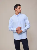 Camisa celeste de manga larga confeccionada en algodón con efecto peach, cuello abotonado y bolsillo en el pecho.