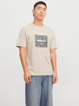 Remera color arena de manga corta y cuello redondo, con estampado cuadrado en el frente con diseño de camuflaje y logo de la marca.