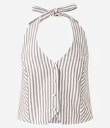 Blusa de jeans con cuello halter y escote en V, diseño a rayas verticales en color beige y blanco. Presenta cierre frontal con botones forrados y lazo para atar al cuello.