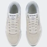 Championes Reebok Classic Leather en tonos gris, beige y blanco, con capellada de cuero y gamuza, forro textil, entresuela de EVA y suela de goma.