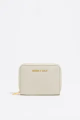 Monedero Bimba y Lola color gris claro, de nylon con estructura blanda. Tiene logo metálico de la marca, cierre con cremallera, tarjetero y monedero interior.