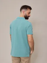 Remera polo celeste de piqué de algodón, corte clásico, con cuello y mangas acanalados.