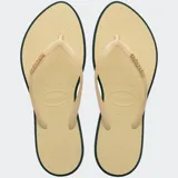 Ojotas Havaianas Slim Point color naranja con borde fucsia y logo fucsia en la tira.