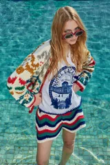 Short tejido a crochet con diseño de rayas en zigzag en colores blanco, azul, verde y rojo.