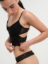 Corset negro de encaje con copas preformadas y breteles finos regulables.