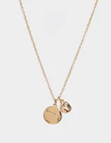 Cadena dorada con dije redondo con el signo zodiacal de aries con strass y dije pequeño con el símbolo de aries.
