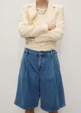 Short de jean azul de corte ancho y largo a la rodilla.
