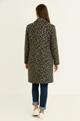 Tapado largo de mujer con cuello solapa y manga larga, confeccionado en tejido estampado pata de gallo en tonos blanco y negro/marrón.