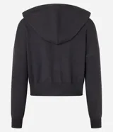 Campera corta de mujer con capucha ajustable con cordón, cierre frontal de cremallera y puños y bajo ajustados. Confeccionada en tejido de punto.