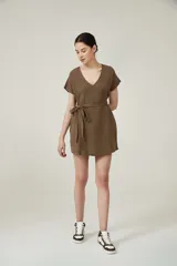 Vestido corto color marrón con escote en V, mangas cortas y lazo en la cintura.
