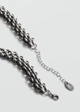 Collar de bisutería con diseño trenzado metálico en tono plateado.