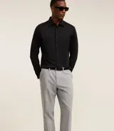 Pantalón de vestir de corte slim, color gris claro, con cintura con trabillas, cierre tradicional, bolsillos laterales y traseros. Confeccionado en algodón, poliéster y elastano.