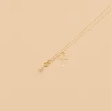 Gargantilla de oro amarillo 18k con dije de cruz calada y dije de cristal en forma de lágrima.