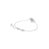 Pulsera plateada con dije en forma de lazo adornado con piedras brillantes y una piedra colgante en forma de pera.