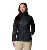Chaqueta híbrida para mujer, color negro, con cuerpo acolchado con aislamiento Thermarator y paneles laterales softshell elásticos. Presenta cuello alto con protección de barbilla, capucha con ribete y cierre frontal con cremallera.