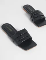 Sandalias negras de cuero sintético con base color suela y tira ancha con tres bandas horizontales.