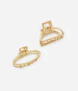 Set de dos pinzas para el pelo doradas, una con forma ovalada y otra semicircular.