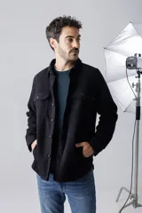 Campera tipo camisa azul marino con cuello clásico, cierre frontal con botones, dos bolsillos con solapa abotonados en el pecho y corte recto.