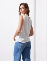Remera negra de modal con escote en V y aplique de puntilla en mangas y escote. Detalle fruncido en hombros.