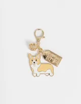 Llavero dorado con dije de perrito corgi, corona y placa con la palabra "London".