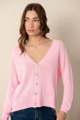Cárdigan de punto color rosa claro, con escote en V y cierre frontal con botones nacarados.