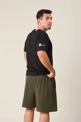 Bermuda deportiva de nylon color gris, de corte suelto, con cintura elástica y cordón de ajuste. Cuenta con detalles de líneas en los costados y bolsillos con cierre.